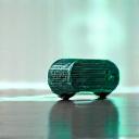 futuristic handheld device glowing with intricate circuits on a clean, sleek surface.