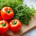 Fresh, colorful vegetables and healthy cooking utensils on a clean kitchen counter.